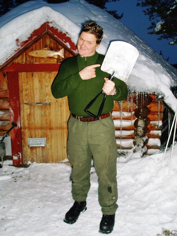 Ray mears holding a shovel in the winter