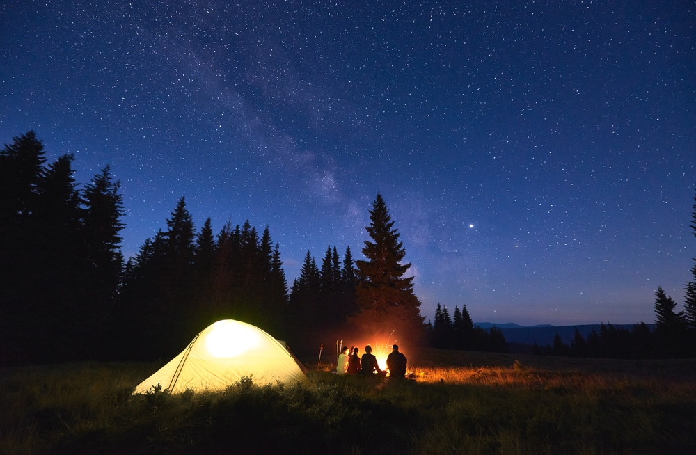 Friends camping in the middle of the night