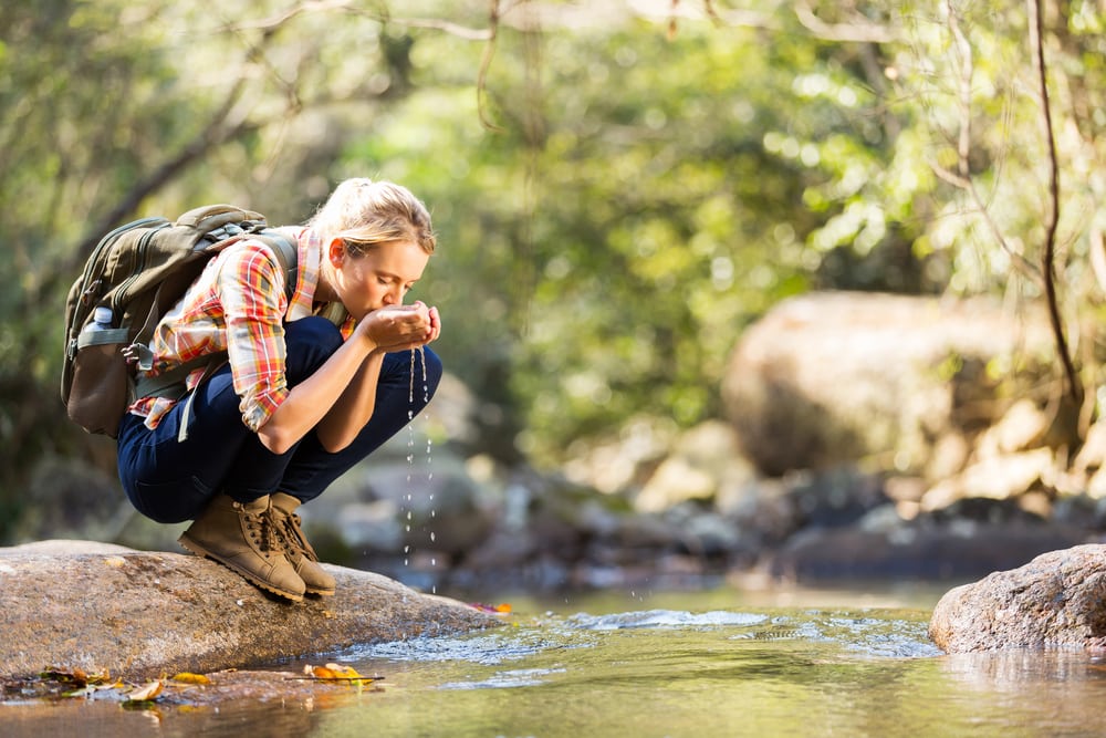 Woman drinking water from hiking