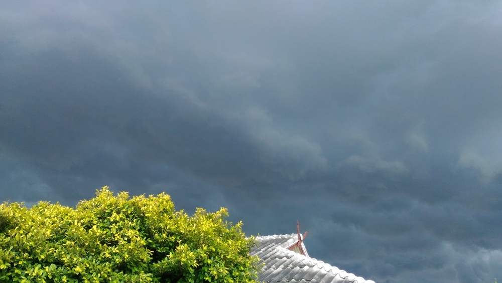 Nimbostratus clouds on top of a home's roof