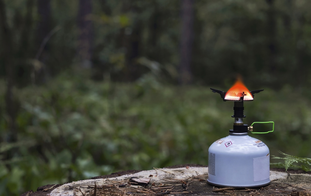 camp stove in night forest
