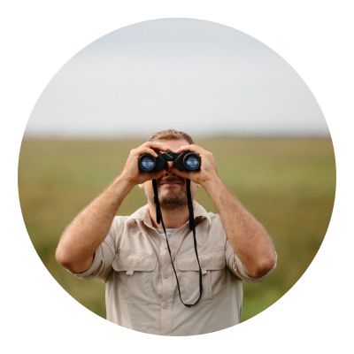 Man using binoculars to see owls