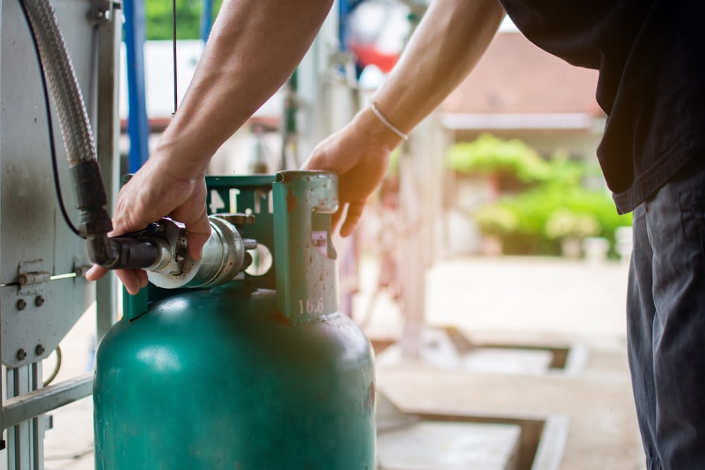 a man refilling a propane gas tank