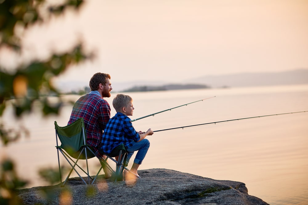 Father and son fishing on a pond