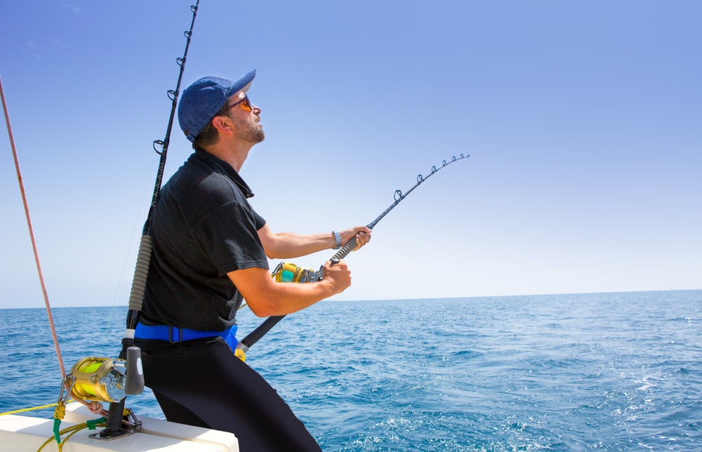 Man pulling up his rod after offshore fishing