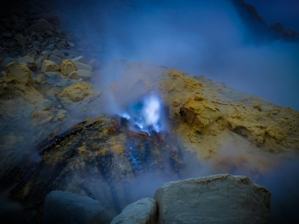Burning sulfur that result in fire with blue illumination and smoke at Kawah Lijen