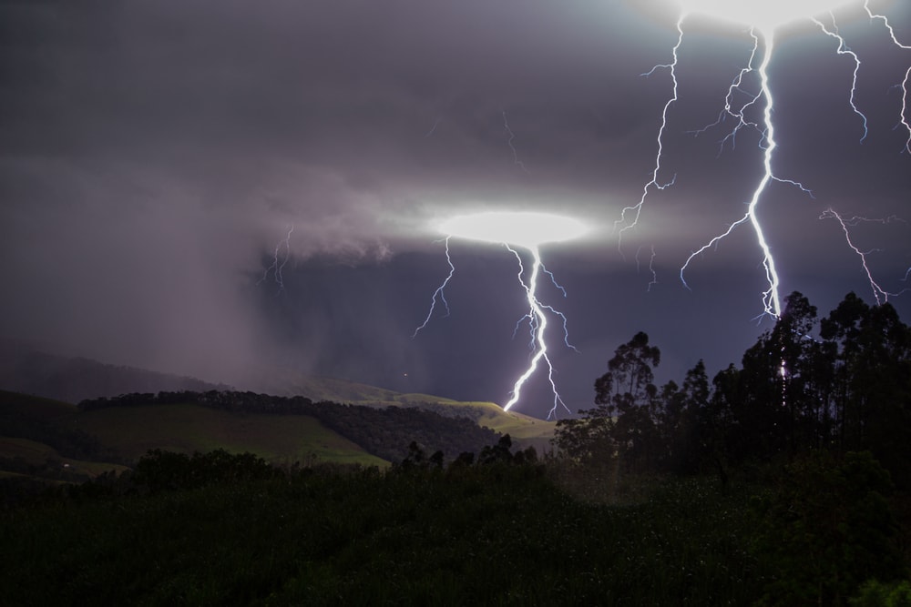 lightning striking over the hills