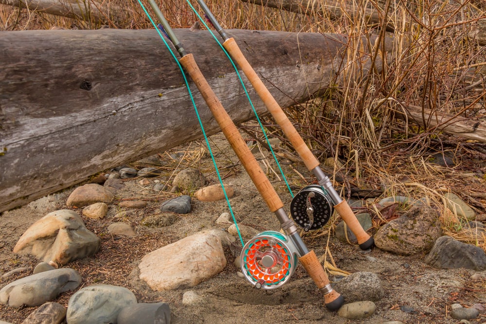 Fly fishing rod resting on a wood