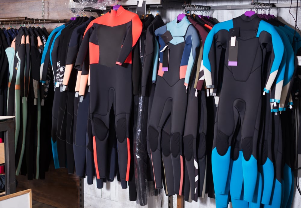 colorful wetsuits on a store