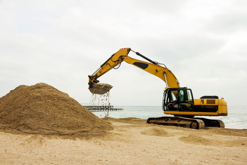 an excavator on a seashore for construction
