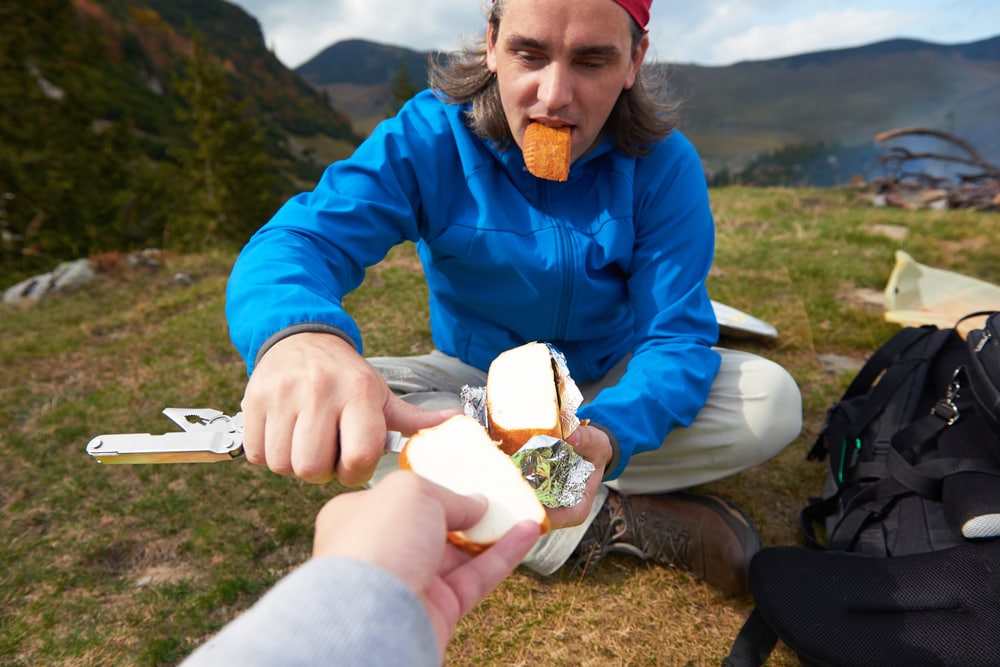 Cheese sliced and given to his friend on a camping