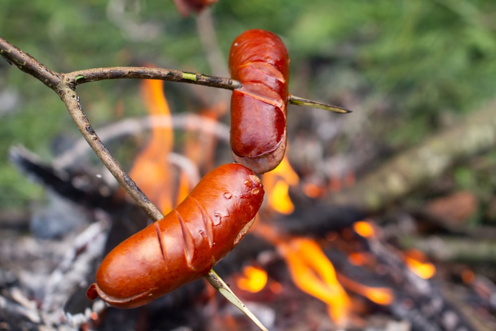 Sausage roasting on a wood