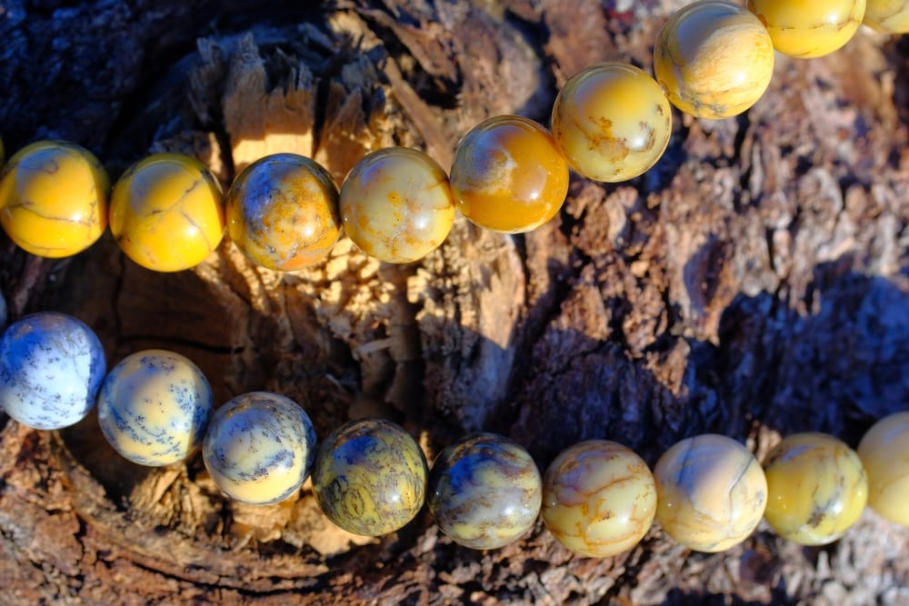Yellow Honey Opals beads on the wood