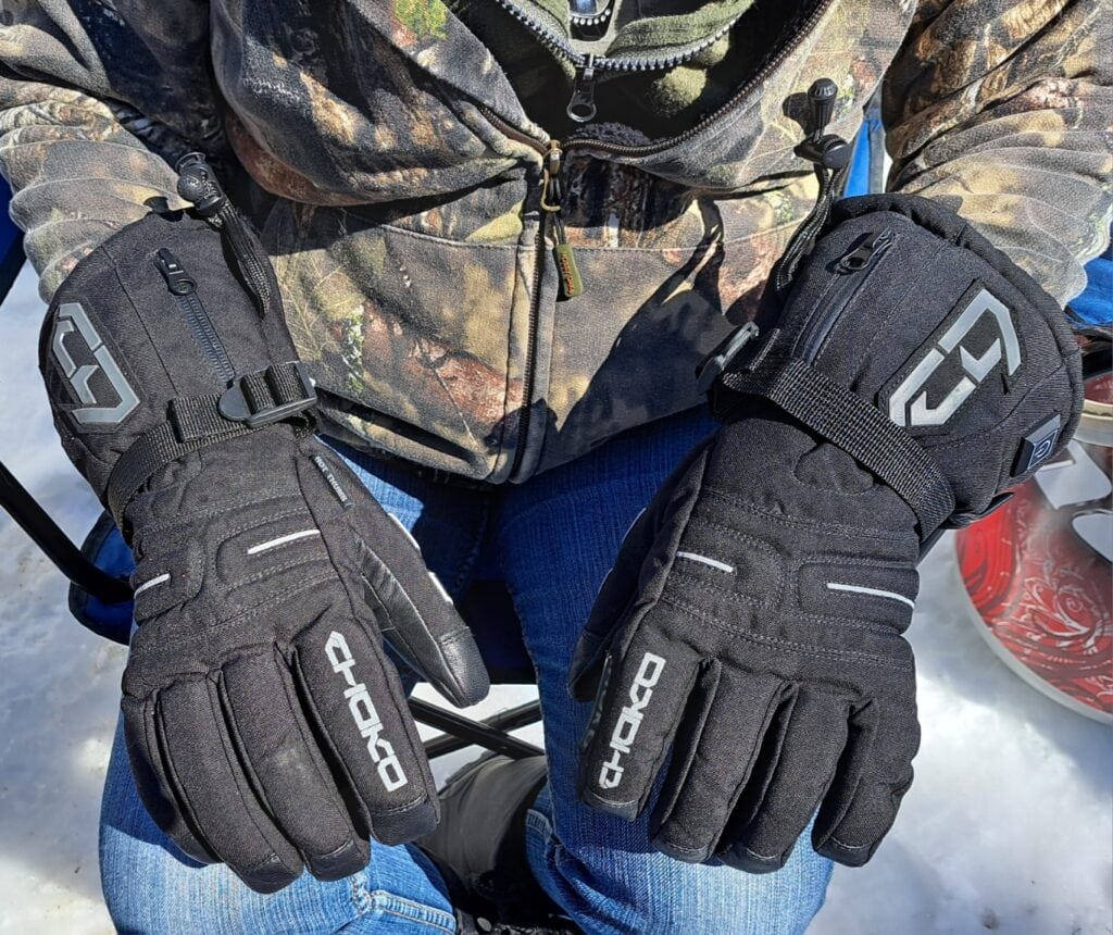 a hand wearing a heated gloves