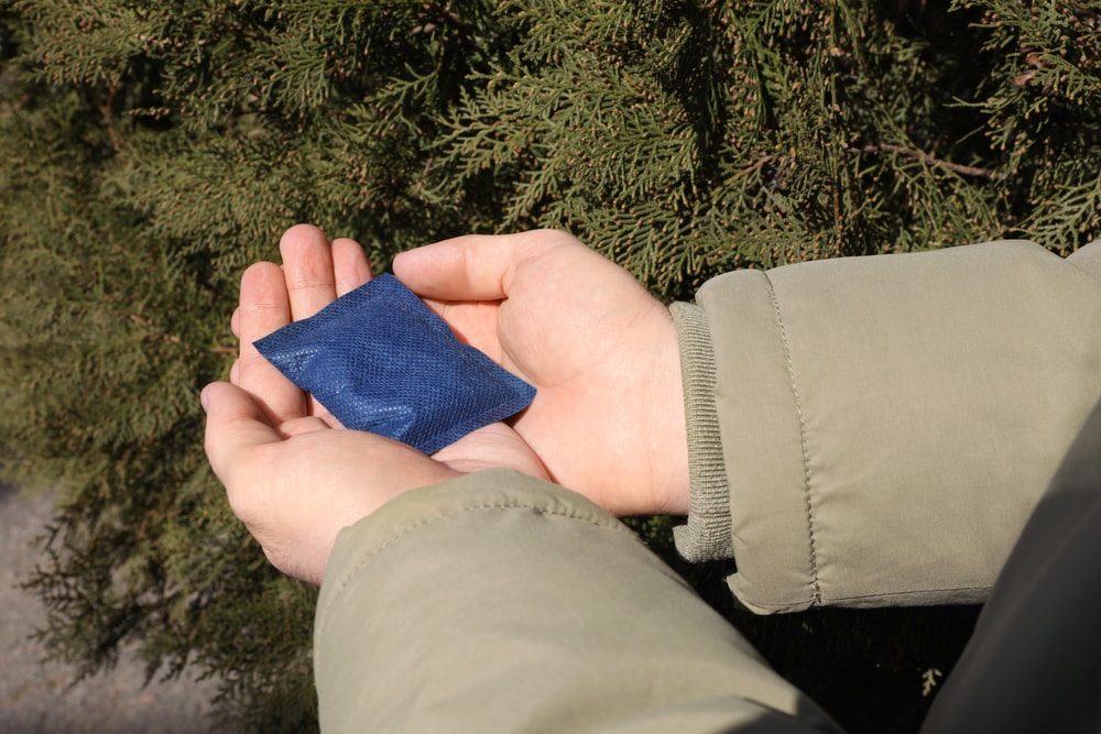 a hand holding a disposable hand warmer
