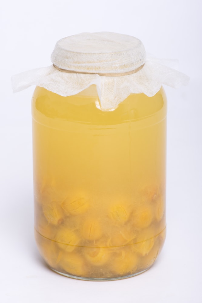 a queen palm juice with fruits in a jar