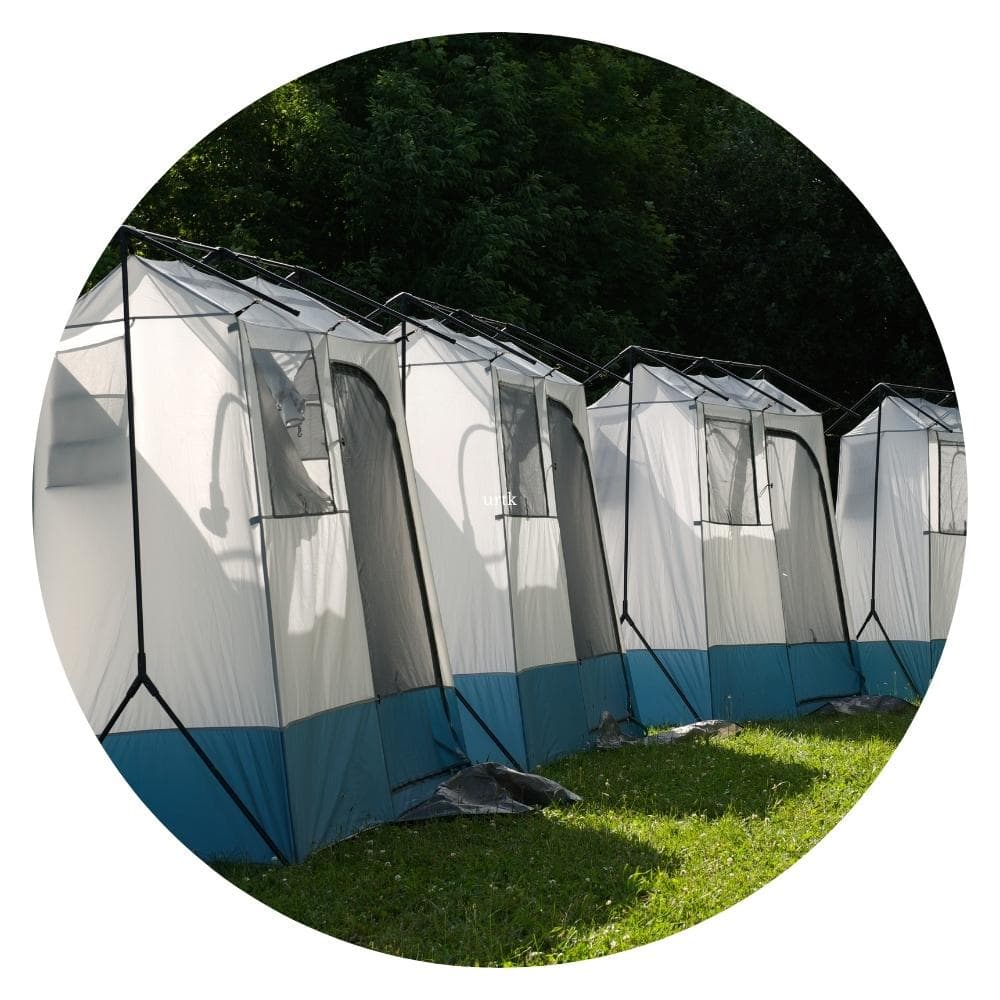 row of shower tents on a campground