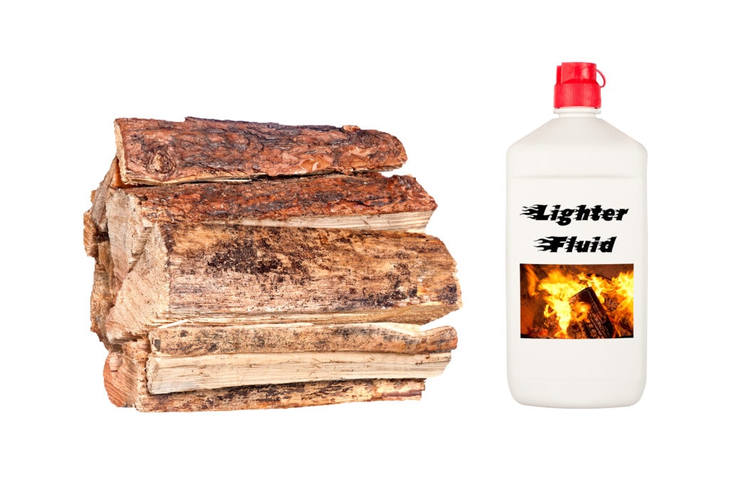 pile of firewood and lighter fluid on a white background