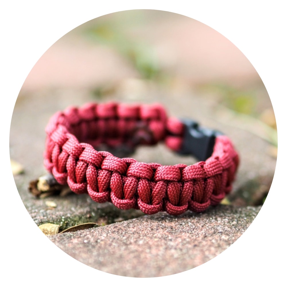 a maroon cobra knot paracord bracelet