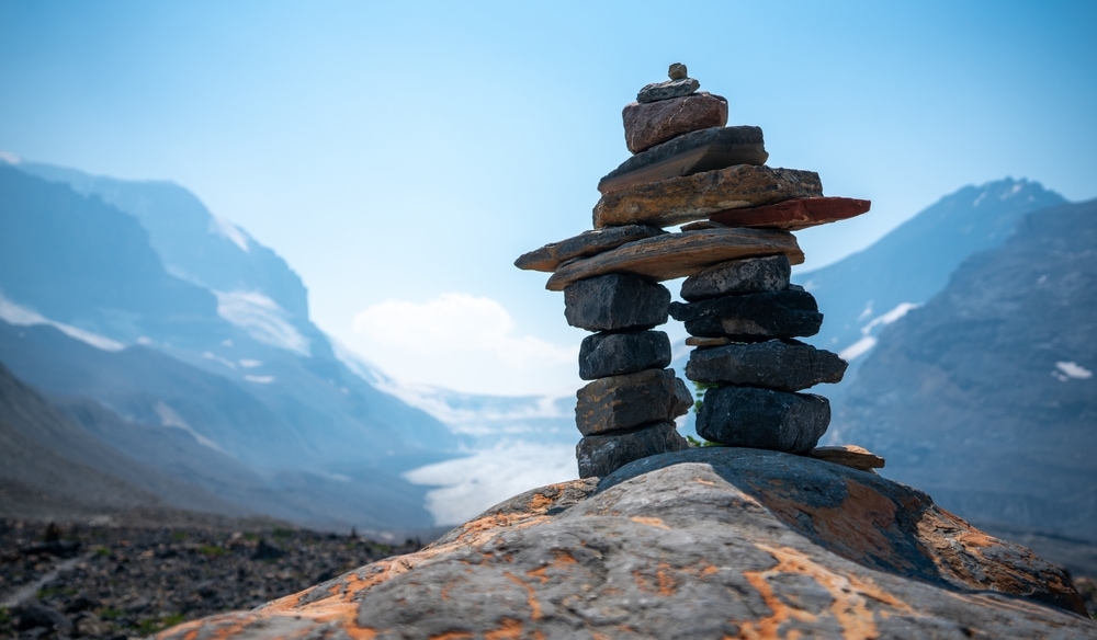 Inukshuk with view of the Athabasca glacier in Alberta.