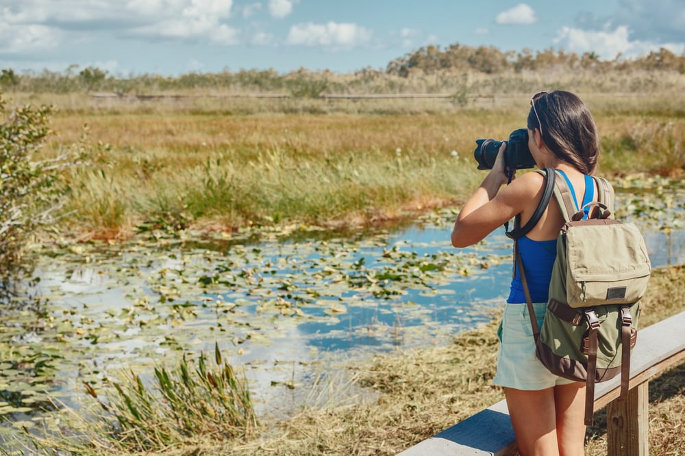 Girl taking a photo of the marsh