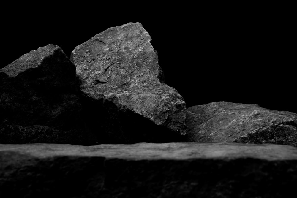 Rocks laying on the ground with black background