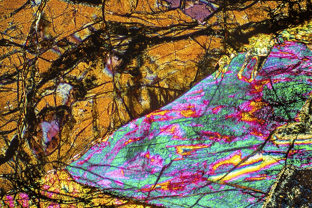 abstract micrograph of peridotite rock