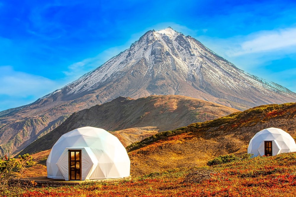 Glamping tents on a volcano landscape