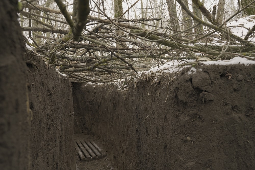 empty infantry trenches covered with tree branches