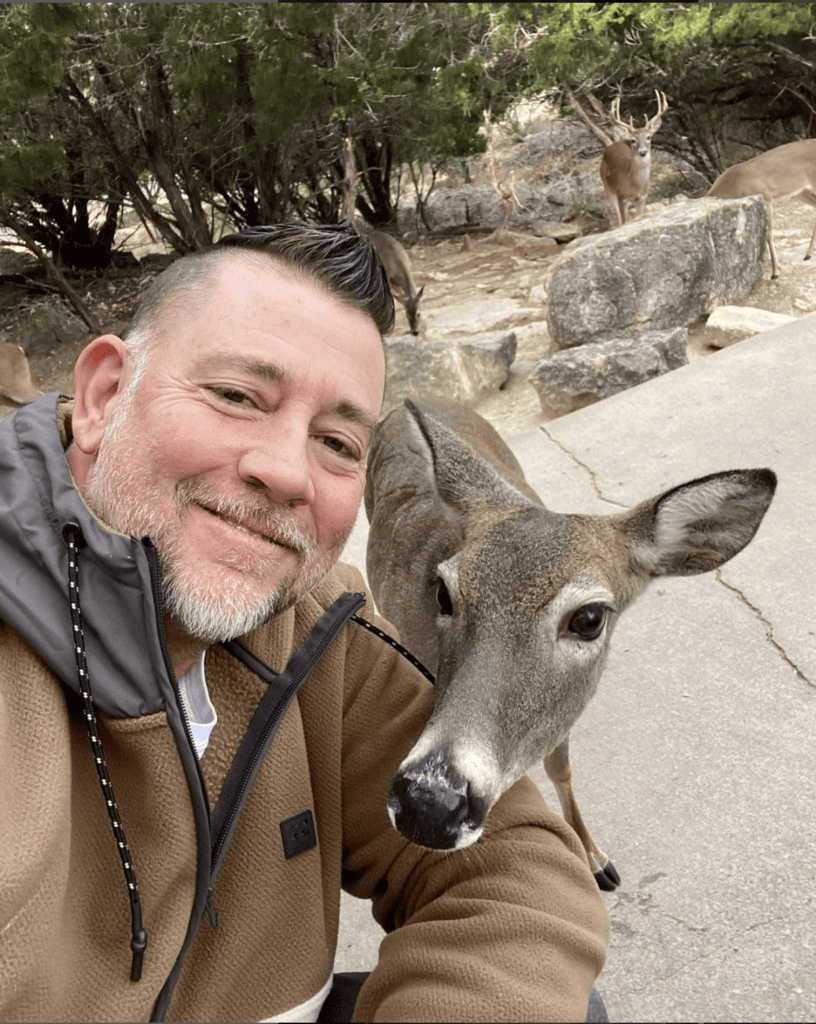 Lynn Smith taking a selfie with a deer